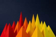 Red, Orange And Yellow Paper Pyramids On A Navy Background. (4)