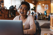 © Chelsea Victoria/Stocksy - A young woman using her laptop in a cafe