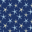 Scattered sea stars seamless pattern on dark blue background textured background. For textiles, swimwear, beach house decor,  gift wrapping paper and beach wedding invitations. Beachy summer look.