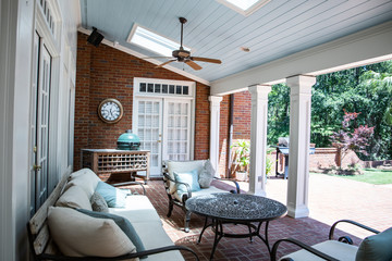 Outdoor Residential Back Patio Porch with Couches and Chairsand a Table