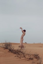 Unrecognizable Woman Dancing In Desert