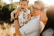 © Erin Drago Photography/Stocksy - Smiling family standing outdoors