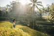© Akela - from alp to alp/Stocksy - beautiful woman overlooking rice fields at sunrise