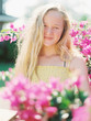 © wendy laurel/Stocksy - blonde teenage girl with long wavy hair with bright colors in summer