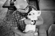 © Jakob Lagerstedt/Stocksy - Bald older man snuggling with a cute small white dog