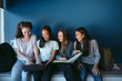 © Rob and Julia Campbell/Stocksy - Four female teens sitting together