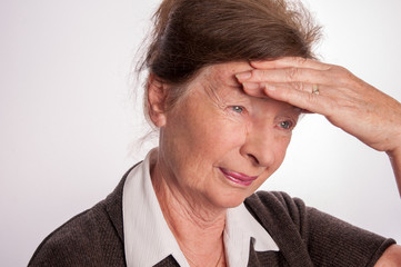 Senior woman wiht headache isolated on white