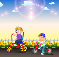 Canvas Print - the two children are riding their bicycle in the afternoon 