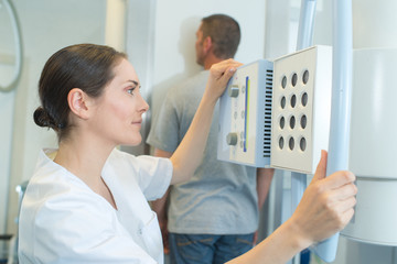 female doctor performing ultrasound test on male patient