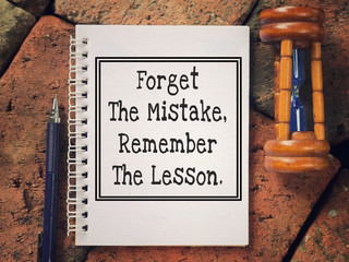 Wall Mural - Motivational and inspirational quote - Forget The Mistake, Remember The Lesson written on a notebook.