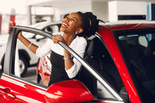 Woman Buying The Car. Lady In A Car Salon. Elegant Black Girl