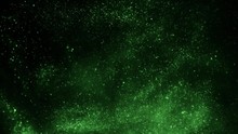 The Explosion Of Green Particles On A Black Background.
