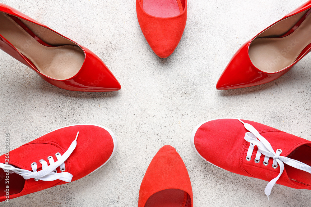 Different stylish shoes on light background