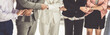 © InfiniteFlow - Business people holding hands together showing partnership, collaboration, trust, teamwork and support.