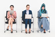 © InfiniteFlow - Business people job applicants sitting and waiting on chairs in office. Job application and recruitment concept.