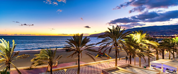 Canvas Print - Panoramic view of Mediterranean beach promenade at sunset sunrise in Almeria, Spain.