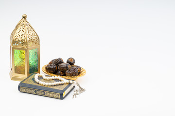 Poster - Lantern, Dates, Koran and Rosary on white background with selective focus and crop fragment. Ramadan, Religion and Copy space concept