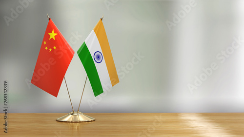 Fotografía Chinese and Indian flag pair on a desk over defocused background