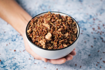 man and bowl of fried red rice with chicken meat