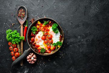 Shakshuka Eggs with tomatoes and vegetables in a frying pan. Breakfast. Top view. Free space for your text.