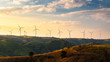 © Satawat - Wind turbines and Orange sunset sky. Beautiful mountain landscape with wind generators turbines,Thailand. Renewable energy concept.