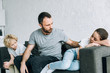 © LIGHTFIELD STUDIOS - two sad preteen children and father having conflict