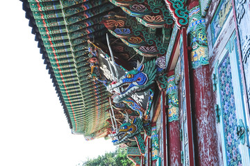 Wall Mural -  Ancient decoration wood carved on the wall and roof in the temple in Pusan, South Korea