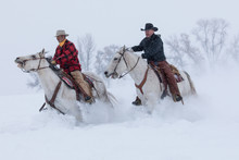Cowboys Riding Horses During Winter