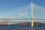 The new Queensferry Crossing bridge over the Firth of Forth with the older Forth Road bridge and the iconic Forth Rail Bridge in Edinburgh Scotland.