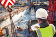 Leinwandbild Motiv engineer on consruction site with tablet computer checking building  plan