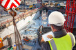 engineer on consruction site with tablet computer checking building  plan