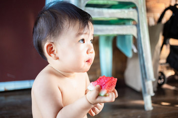 Wall Mural - Cute Asian baby girl eating watermelon, Female kid enjoy eating watermelon  