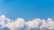 Top of white fluffy clouds and blue sky background