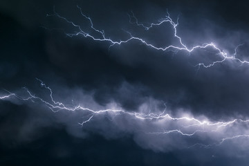 Wall Mural - lightning bolts crawl through the sky just below the anvil of a severe thunderstorm over the great p