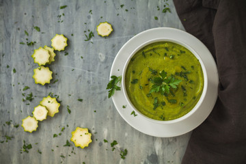 Fresh vegan plate of zucchini cream soup