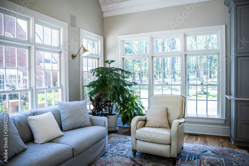Neutral Color Couches And Chair In Well Lit Airy Living Room
