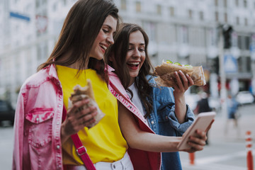 Wall Mural - Happy females making selfie due lunch break