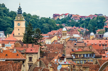 Canvas Print - View the roofs of Old Town buildings in Brasov with Council House tower on the left side, Romania