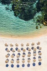 Wall Mural - View from above, stunning aerial view of a white beach with beach umbrellas and turquoise clear sea. Emerald Coast (Costa Smeralda), Sardinia, Italy.