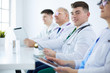 © lenets_tan - Medical team sitting and discussing at table