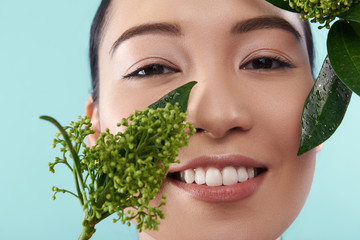 Sticker - Portrait of happy Asian lady posing with branch of plant