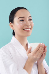 Wall Mural - Half length of charming Asian lady with patches under eyes in studio