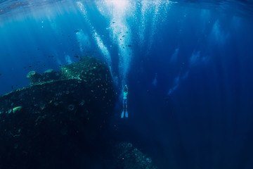 Wall Mural - Freediver man dive underwater at shipwreck in Bali. Freediving in ocean