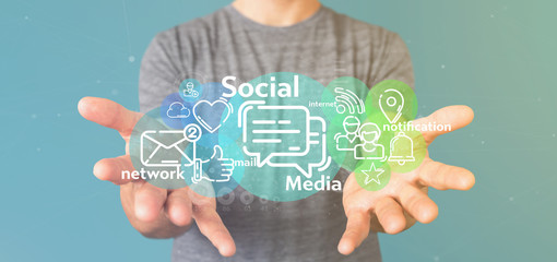 Businessman holding a cloud of social media network icon