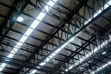 Fototapeta  - Roof steel beam structure in Industrial factory, Background of factory ceiling with one light blub, Abstract background