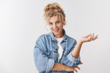 Wall Mural - Wellbeing, happiness lifestyle concept. Attractive stylish glamour carefree blond curly-haired woman blue eyes smiling joyfully talking gesturing raised palm look relaxed delighted, upbeat mood