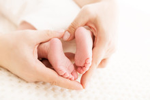 Newborn Baby Feet In Mother Hands, Mom Massaging New Born Kid Foot, Health Care