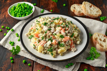 Russian traditional salad Olivier with vegetables and meat.