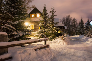 Evening lighted wooden house