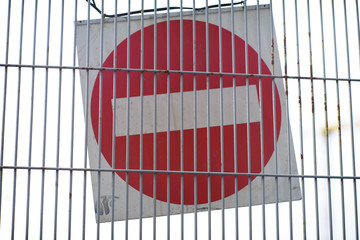 Wall Mural - Red and White British No Entry Road Sign with Steel Fence, Red Stop Road Sign, Traffic Sign Prohibiting, Fence Grilles Rust Texture Background, Warning Sign at Fence Wall, Prohibition Sign